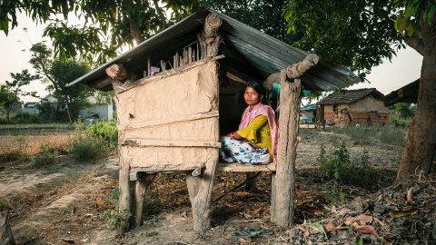 A woman sitting in a hut in rural Nepal.
