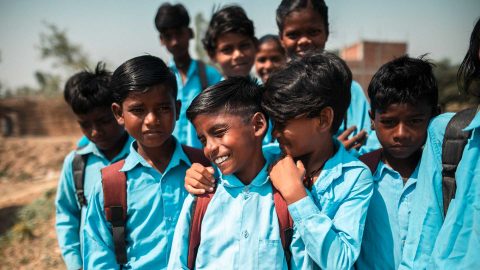 A group of school children smiling in Nepal.