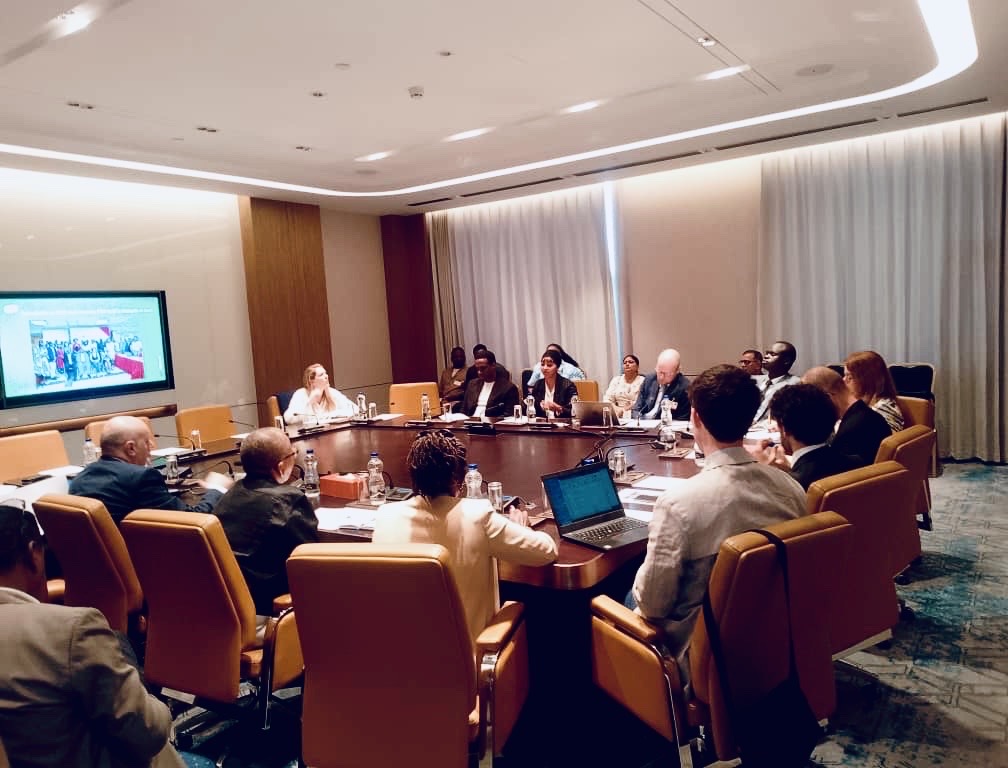 Several people sitting at a conference table.