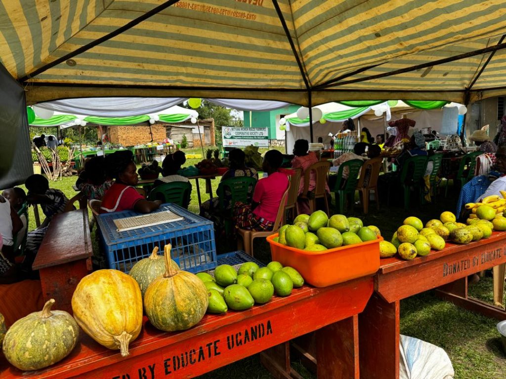 A picture of fruits like pumpkin, pawpaw and banana in a market stall