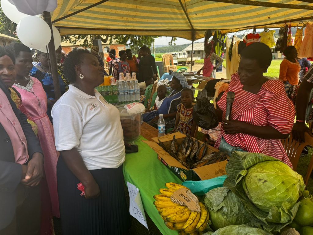 A woman selling fish to another woman at a market