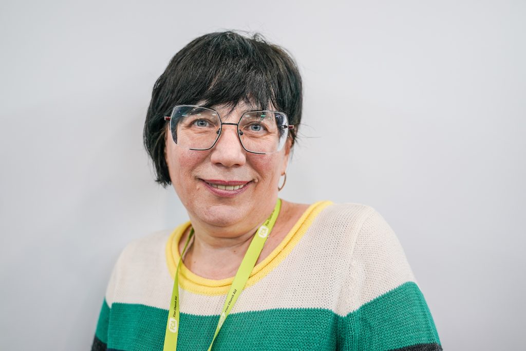 A smiling woman poses for a photograph. 